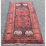 A Hamadan rug, the black field with two large polychrome serrated medallions within three borders,