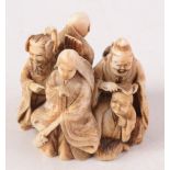 A Japanese ivory netsuke carved as a group of figures representing the six famous poets (Rokkasen),