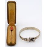 A cased gold stick pin with cameo finial, together with a silver belt bangle.