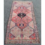 A Lori Persian rug, the red and camel sectional field decorated with medallions, guls and boteh,