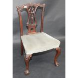 A set of three Chippendale style ornately carved, mahogany dining chairs with cabriole legs.