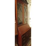 An Edwardian satinwood crossbanded, slope front bureau bookcase.