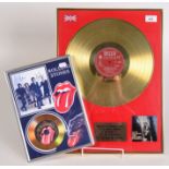 The Rolling Stones, an Out of Our Heads gold disc and a Fifty Years 7" disc.