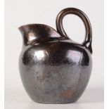 A studio pottery jug in the style of Christopher Dresser, height 14.5cm.