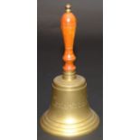 A large brass bell, inscribed 'Captain's table', with a turned wood handle, height 41cm.