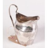 A silver George III helmet cream jug. 2.5oz.