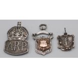 A gold mounted silver prize medallion, a silver A.R.P. badge and one other piece.