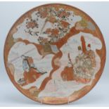 A Japanese Kutani charger decorated with two exotic birds perched on a flowering branch and figures