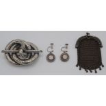 A chased Victorian silver brooch, a silver small purse and a pair of silver earrings.