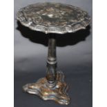 A Victorian papier mache tripod pedestal table.