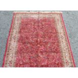 A rug, the red field decorated with flowering trees, birds and animals,