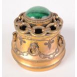 A continental brass inkwell, 19th century, the hinged cover with a malachite cabochon, height 7.5cm.