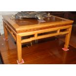 A Chinese hardwood low centre table with a huali wood square panel to the top above a pierced