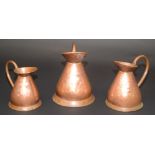 Three copper bellied measures, heights 34, 30 and 24cm.