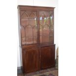 A George III mahogany bookcase the upper section with lancet lattice glazed doors,