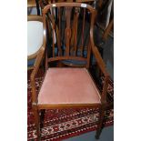 An Edwardian inlaid mahogany armchair on square section tapering legs.