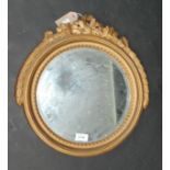 A small gilt framed mirror with circular bubbled plate.