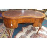 A good figured walnut veneered kidney shaped pre war desk,