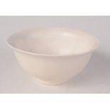 A Chinese white glazed bowl of rounded form with flared rim, height 6cm, diameter 12cm.