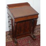 A William IV rosewood veneered Davenport with 'S' scroll front support,