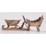 A Dutch silver miniature cradle and a silver salt in the form of a sleigh.