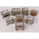 Seven gilt metal and cut glass jewel boxes and another containing two glass and gilt metal mounted