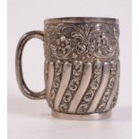 A late Victorian spiral fluted embossed and chased christening mug. 5oz.