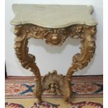 An 18th century carved and gilt small console table with marble top, in Louis XV style.