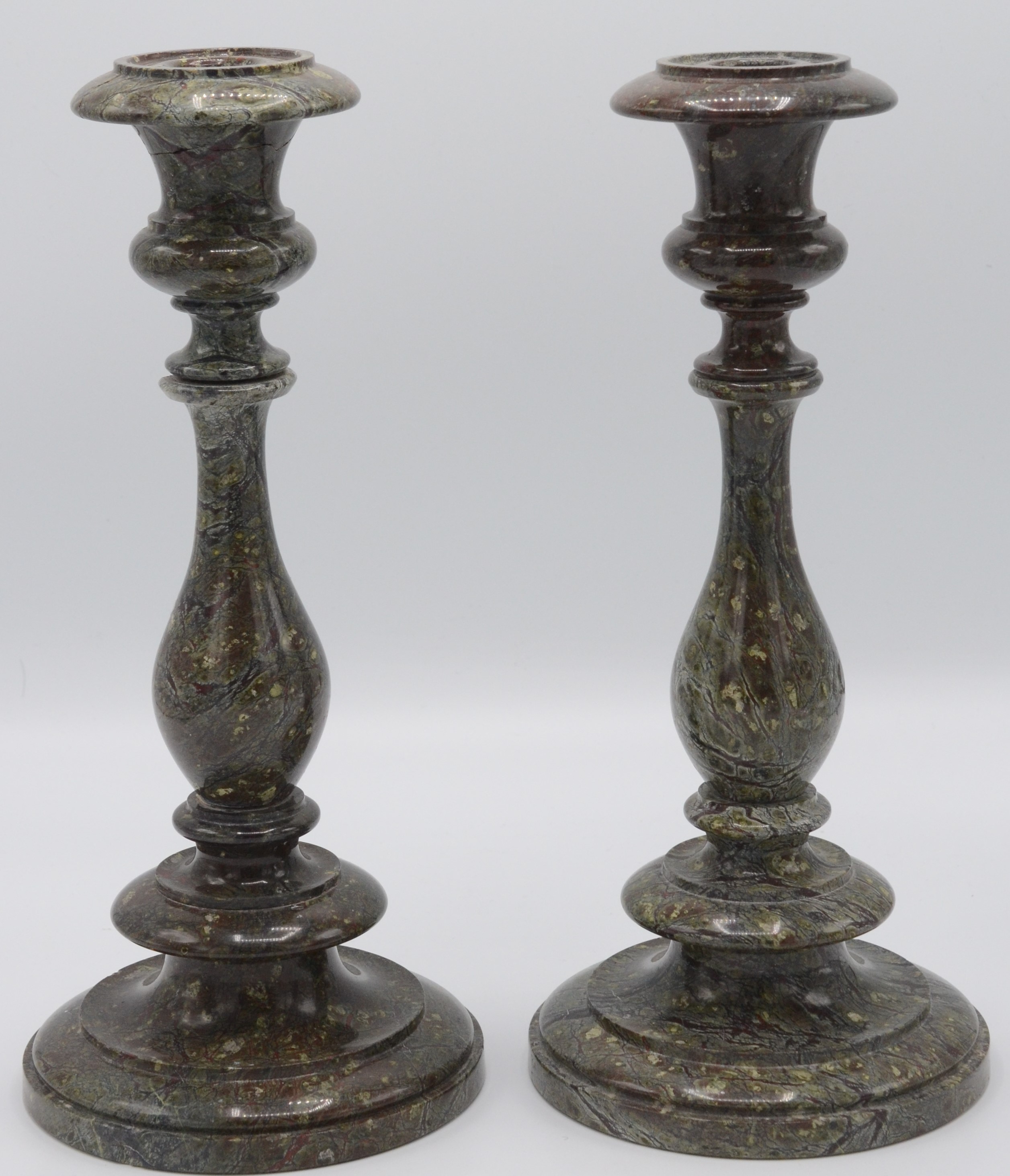 A pair of Cornish serpentine candlesticks,