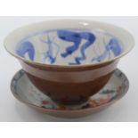 A Chinese cafe au lait bowl, the blue and white interior decorated with a stylised fish,