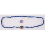 A faceted Pakistani amethyst and a lapiz lazuli necklace.