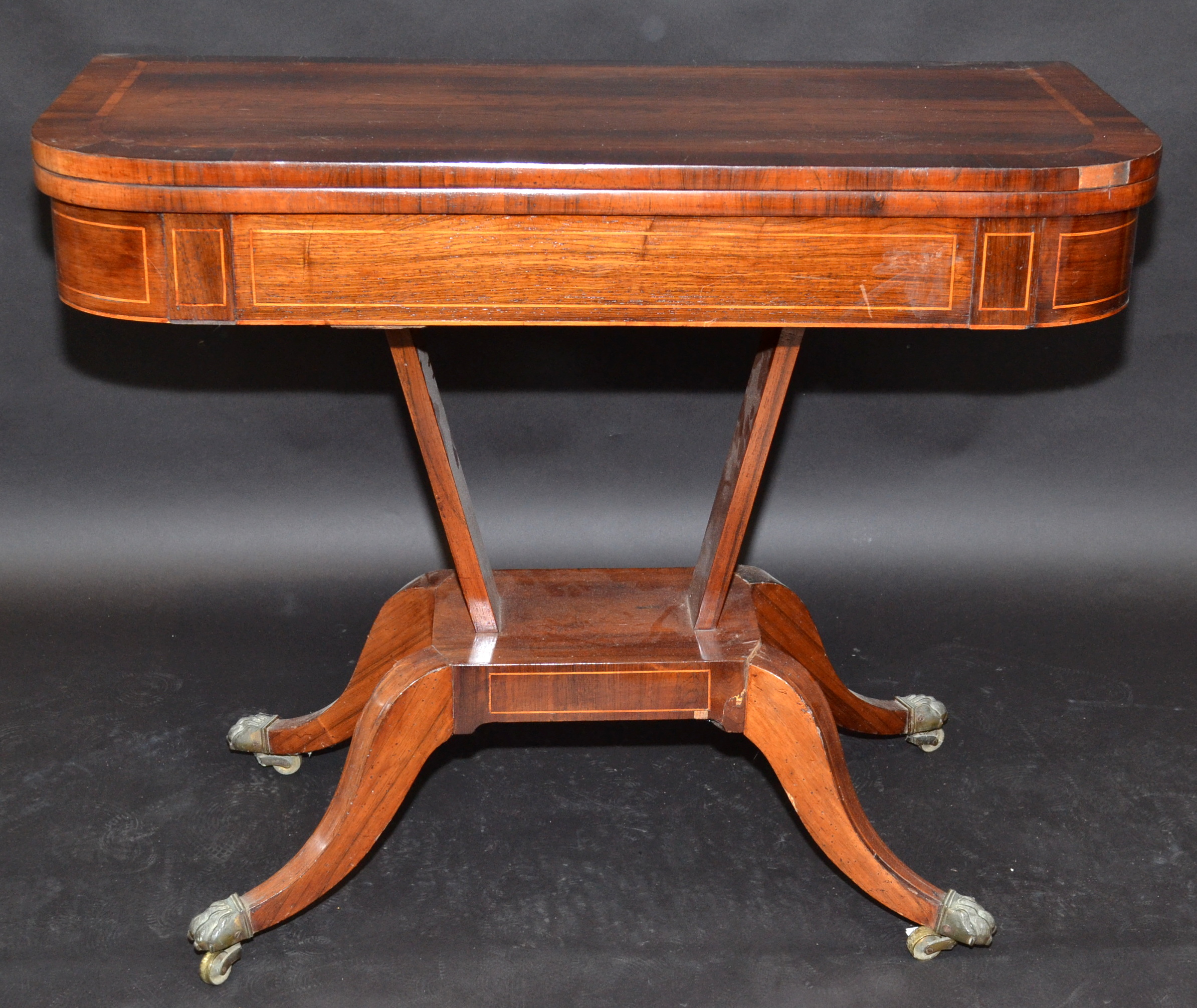 A Regency inlaid, fold top card table on four sabre legs with lions paw feet, width 91.5cm. - Image 2 of 3