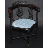 A late Victorian carved corner chair.