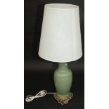 A Chinese celadon glazed vase, converted to a table lamp, mounted on a pierced gilt metal base,