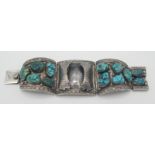 A silver hinged bracelet set matrix turquoise and with retaining clips to hold a watch.