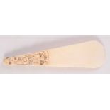 A Chinese ivory shoe horn, the handle carved with a dragon, length 18.5cm.