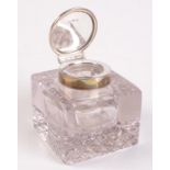 A glass inkwell with silver mount.