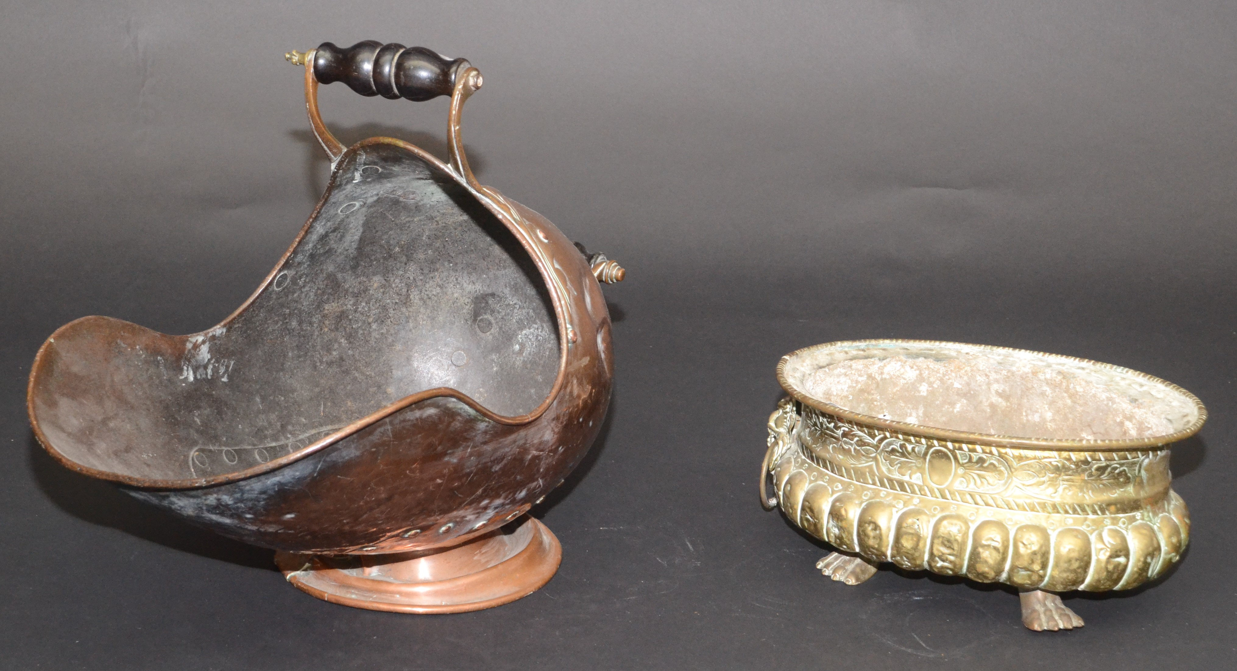 A Victorian copper coal helmet and an oval brass jardiniere stand.