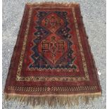 An Afshar rug, South West Persia, the indigo field with a madder linked hexagonal medallion,