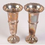 A pair of silver spill vases, each with shaped rim and stemmed foot, height 20cm. 10oz.