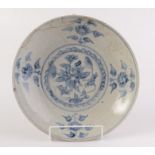 A Chinese South East Asian Export saucer dish decorated in under glaze blue on a crackled creamy