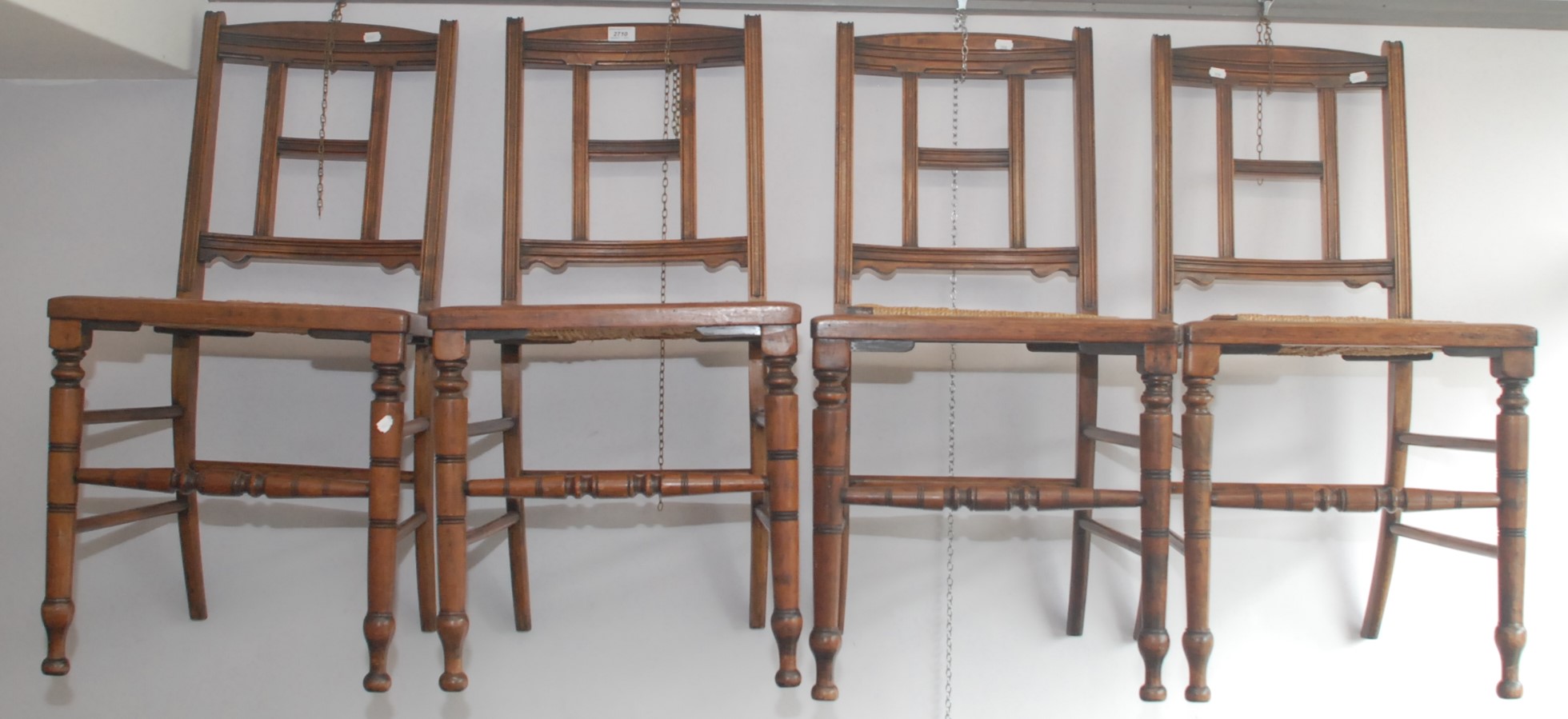 A set of four high Victorian chairs with rush seats.