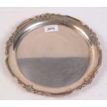 A silver tray with cast border, Sheffield 1958, diameter 25.7cm.