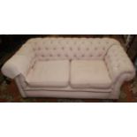 A buttoned Chesterfield sofa with single drop end.
