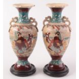 A pair of Japanese Satsuma baluster vases, each with panels decorated with warriors,