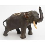 A Japanese bronze silver mounted match striker in the form of an elephant,