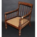An early Victorian library chair in rosewood stained beech,