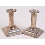 A pair of filled silver low candlesticks by the Goldsmiths & Silversmiths Co Ltd London 1905.