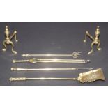 A set of three brass fire implements, a pair of fire dogs and a toasting fork.