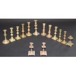 A selection of fourteen Victorian and later brass candlesticks, height of largest 25cm.